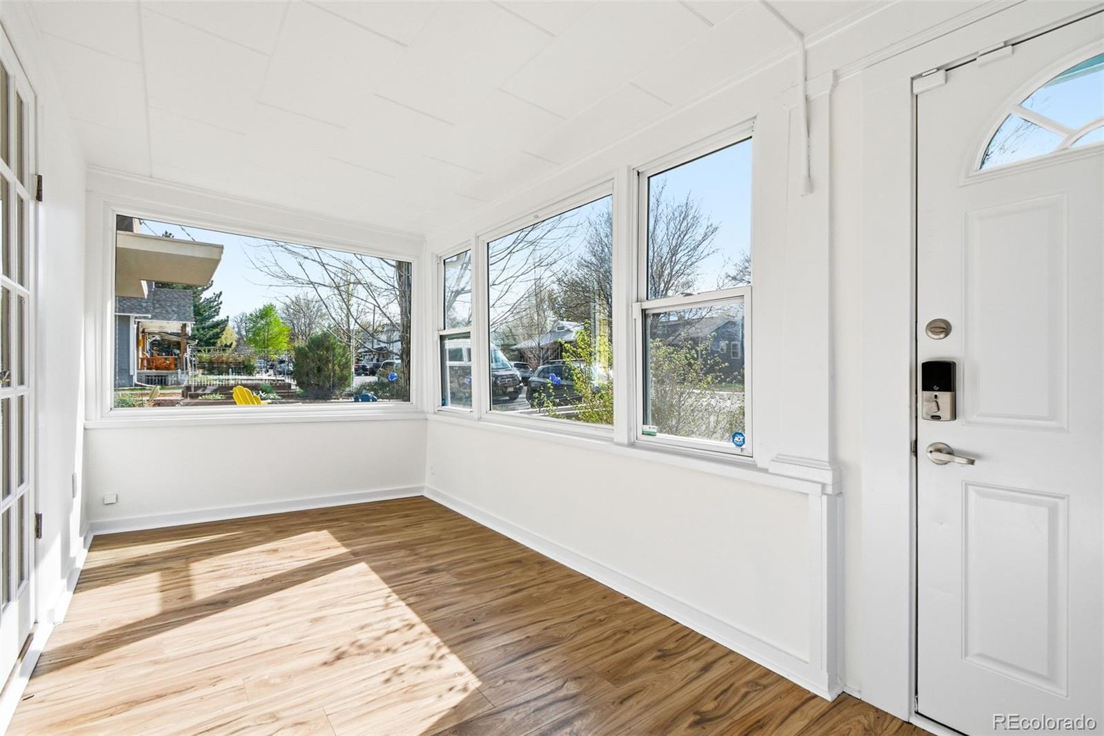 4182 Yates Street Denver, CO 80212 - Photo 4 of 48 a view of an empty room with wooden floor and a window
