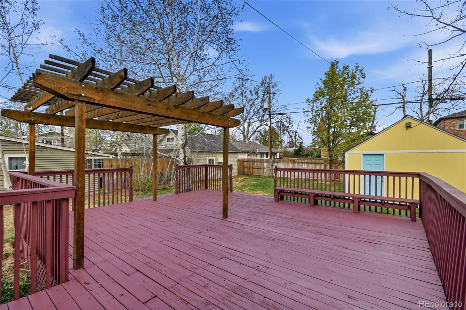 4182 Yates Street Denver, CO 80212 - Photo 42 of 48 a view of a deck with wooden floor and fence with a garden