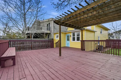 a view of a yard with wooden fence and a bench