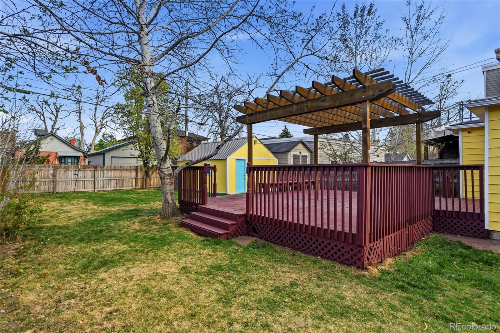 4182 Yates Street Denver, CO 80212 - Photo 45 of 48 a view of a yard with wooden fence and a bench