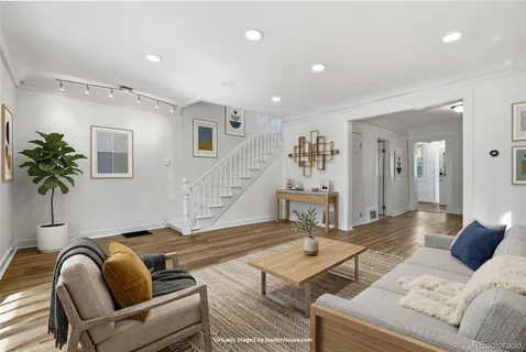 a living room with furniture and a potted plant