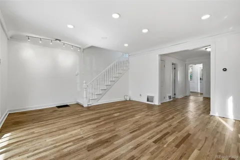 a view of an empty room with wooden floor