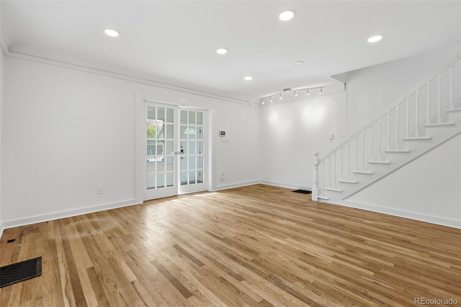 4182 Yates Street Denver, CO 80212 - Photo 10 of 48 a view of an empty room with wooden floor and a window