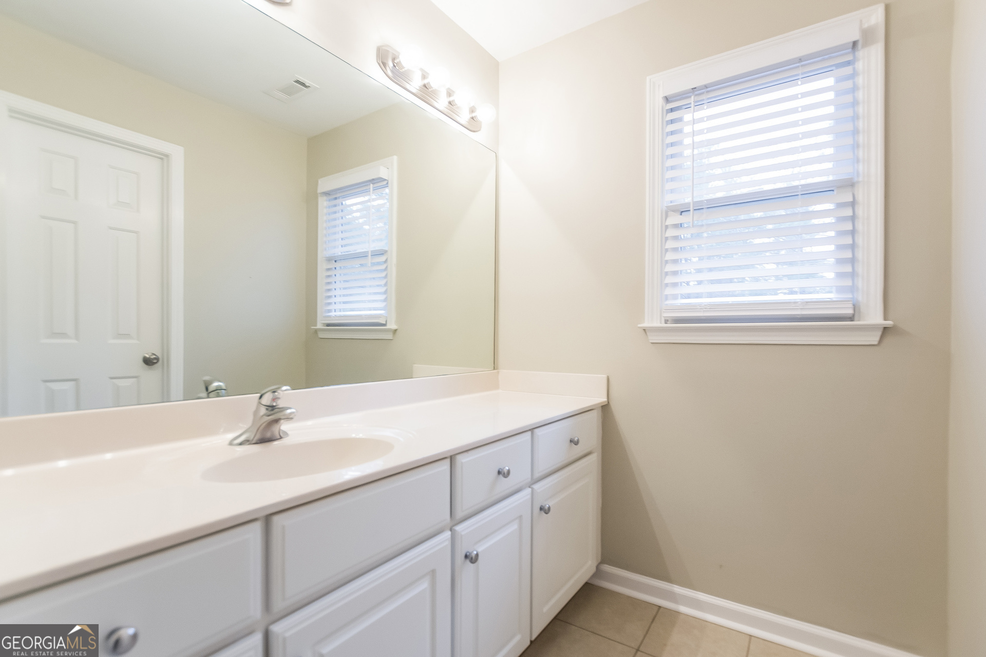 2485 Worthington Drive Powder Springs, GA 30127 - Photo 13 of 15 a bathroom with a sink and a mirror