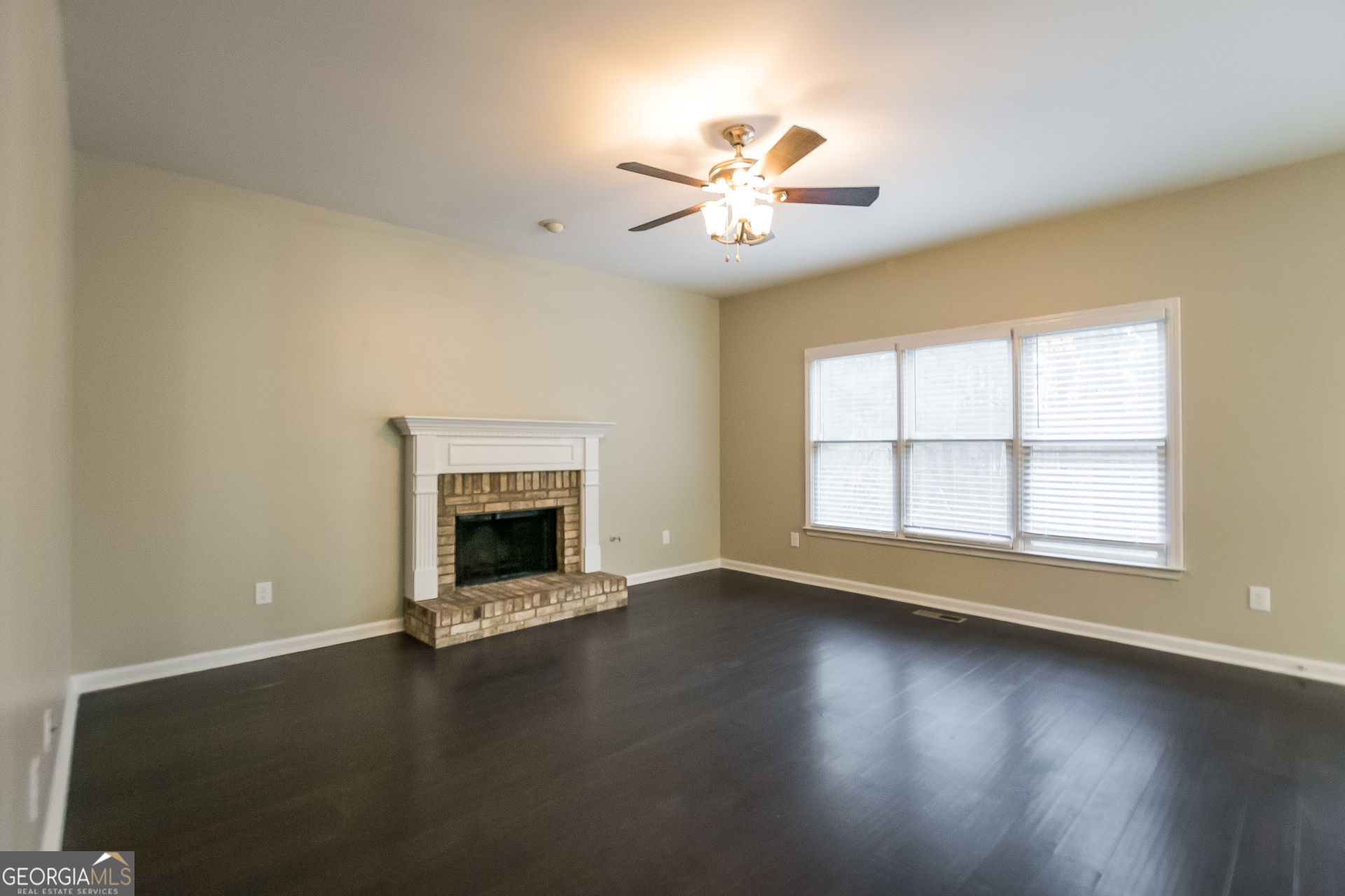 2485 Worthington Drive Powder Springs, GA 30127 - Photo 3 of 15 a view of an empty room with wooden floor fireplace and a window