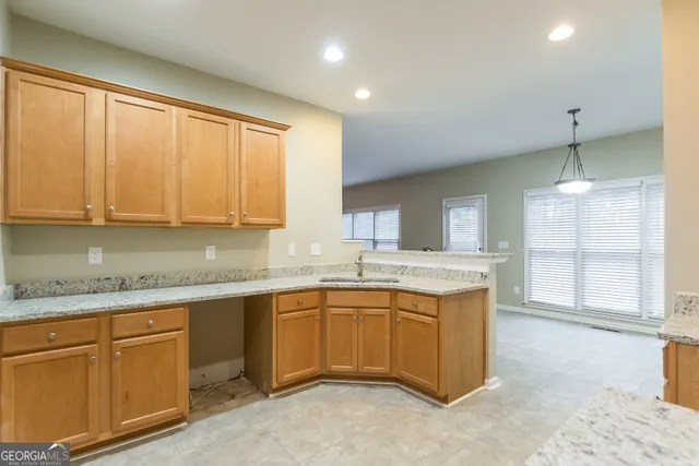 a kitchen with sink and cabinets