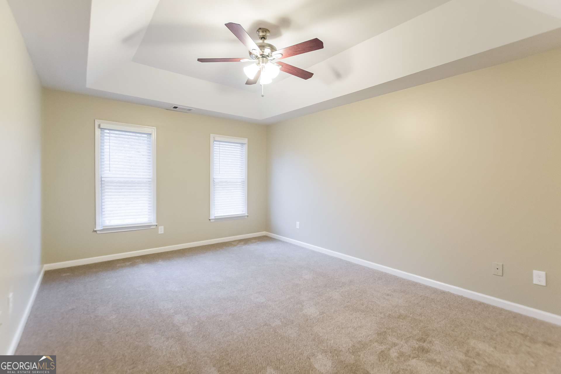 2485 Worthington Drive Powder Springs, GA 30127 - Photo 8 of 15 an empty room with a window and a ceiling fan