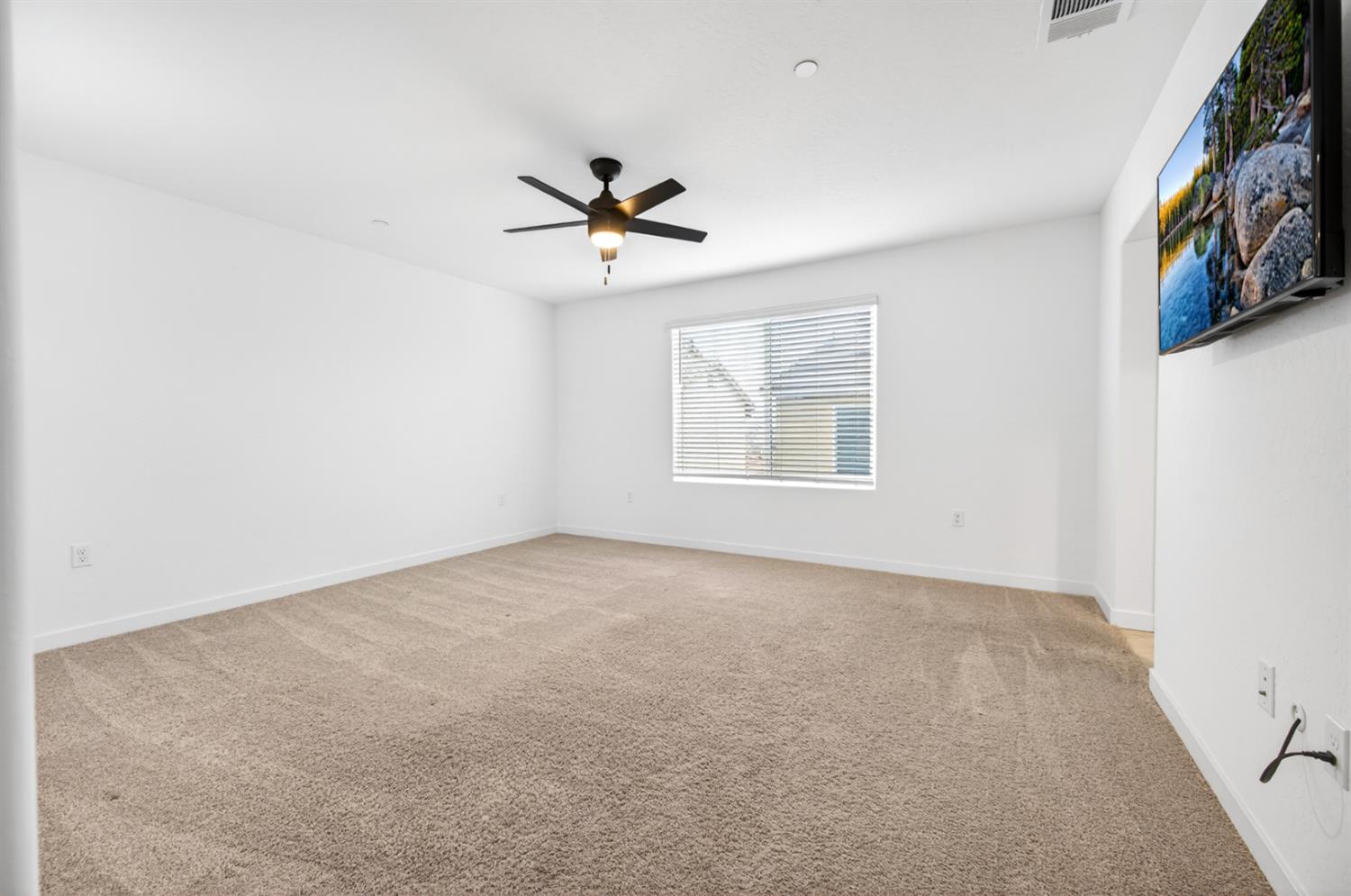 317 Talus Way South Madera, CA 93636 - Photo 26 of 61 an empty room with windows and fan