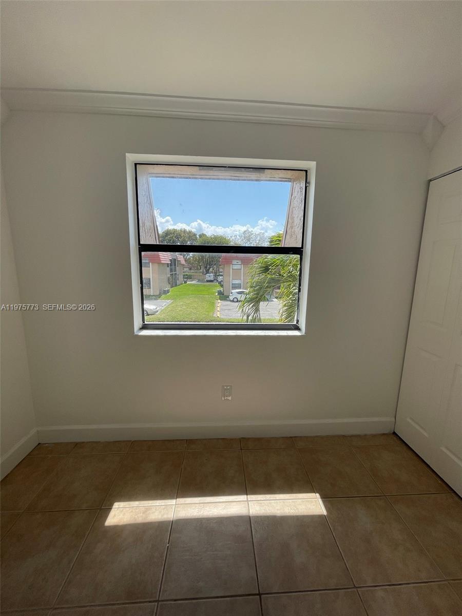 14915 Southwest 104th Street, Unit 2024 Miami, FL 33196 - Photo 15 of 34 a view of a small space with wooden floor and a window