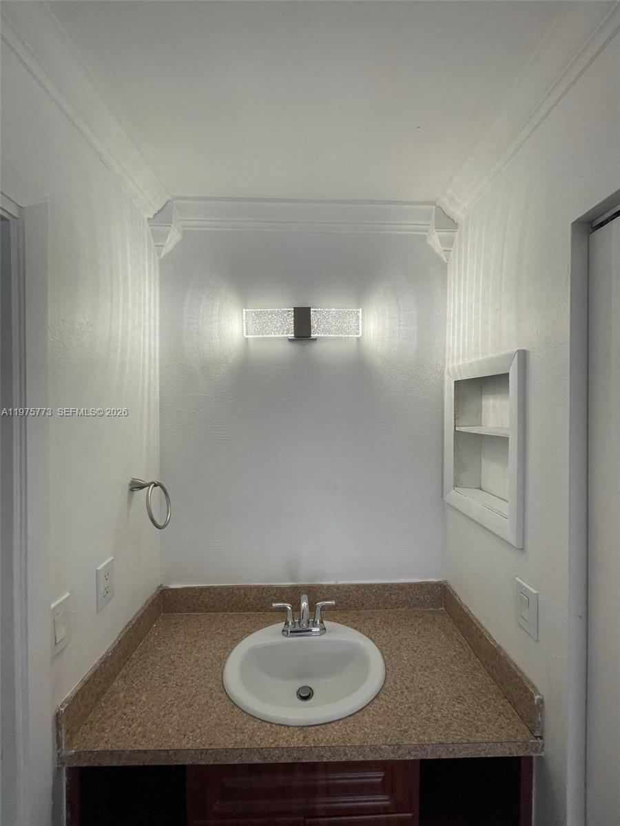 14915 Southwest 104th Street, Unit 2024 Miami, FL 33196 - Photo 19 of 34 a bathroom with a sink and a mirror