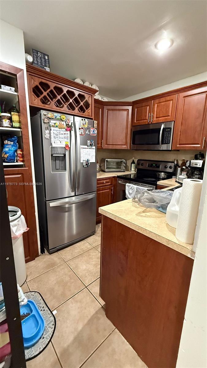 14915 Southwest 104th Street, Unit 2024 Miami, FL 33196 - Photo 24 of 34 a kitchen with stainless steel appliances granite countertop a refrigerator a stove and a sink