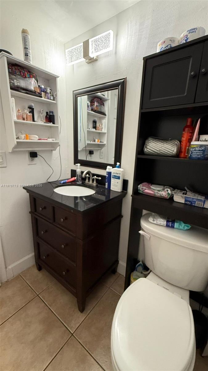 14915 Southwest 104th Street, Unit 2024 Miami, FL 33196 - Photo 25 of 34 a bathroom with a toilet sink and mirror
