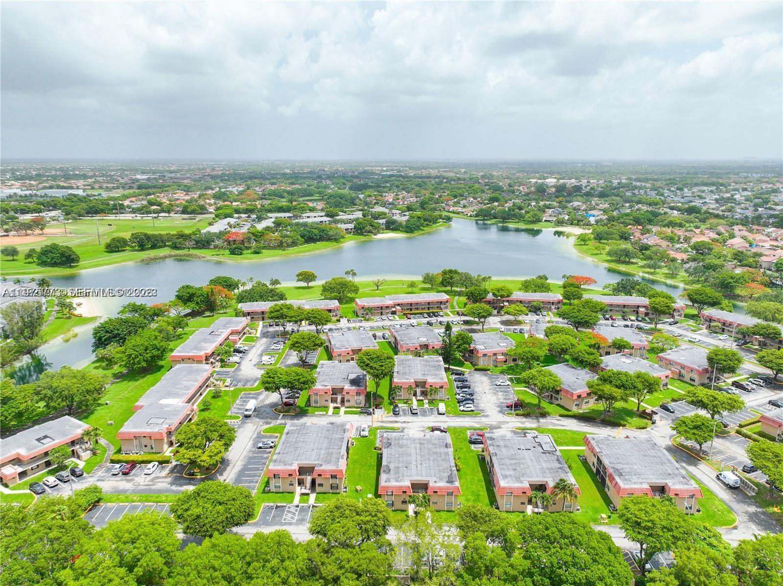 14915 Southwest 104th Street, Unit 2024 Miami, FL 33196 - Photo 32 of 34 an aerial view of residential building and lake