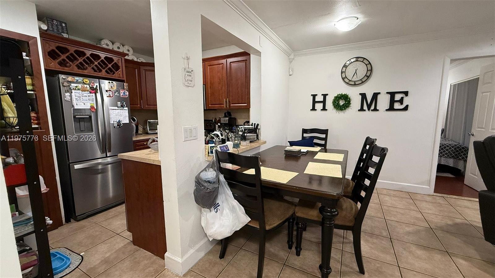 14915 Southwest 104th Street, Unit 2024 Miami, FL 33196 - Photo 6 of 34 a dining room with furniture and a refrigerator