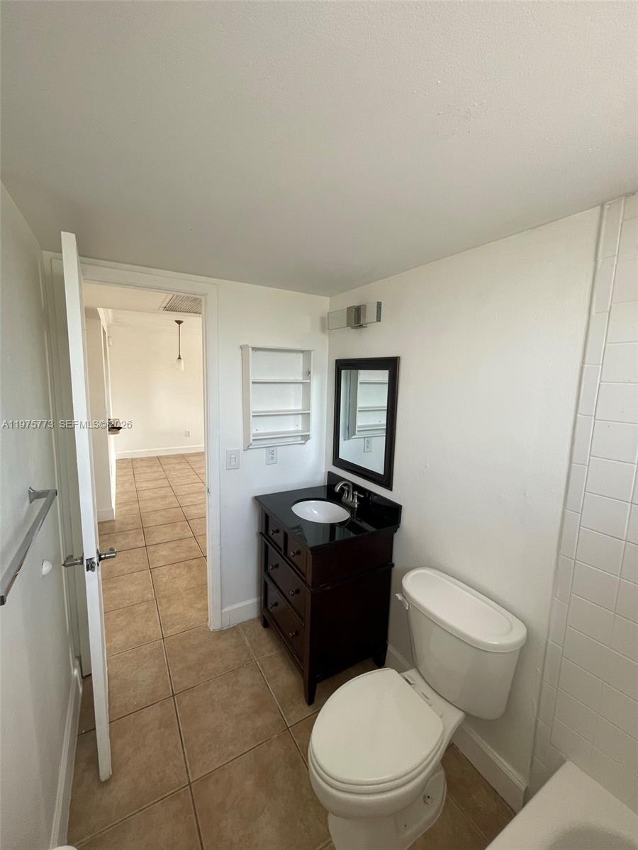 14915 Southwest 104th Street, Unit 2024 Miami, FL 33196 - Photo 7 of 34 a bathroom with a toilet a sink a shower and mirror