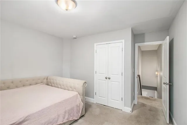 a spacious bedroom with a bed and a chandelier