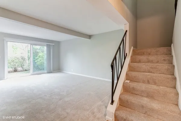 a view of an empty room with stairs