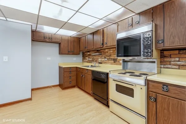 a kitchen with a stove microwave and sink