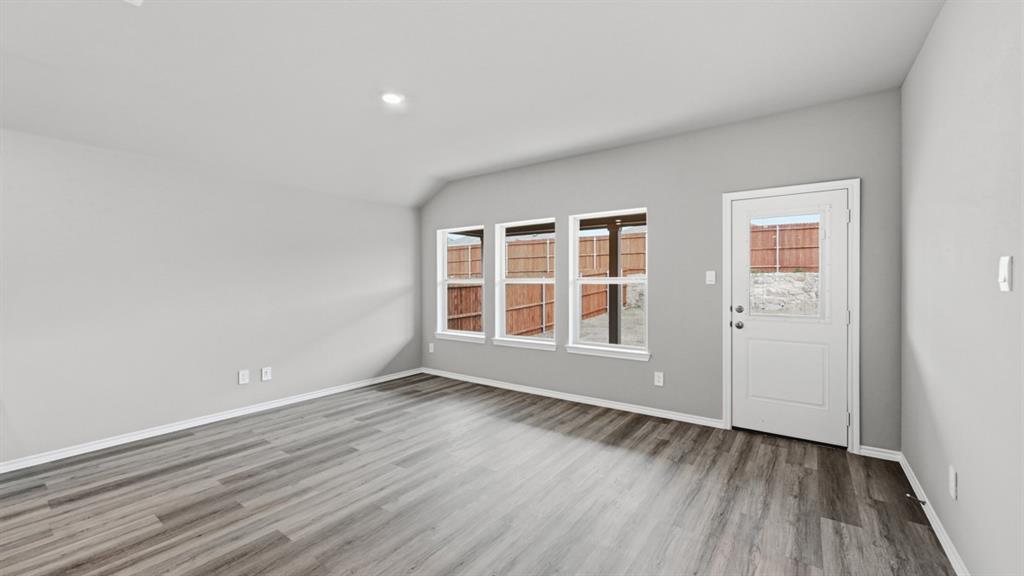 1632 Tin Roof Road Krum, TX 76249 - Photo 10 of 34 an empty room with wooden floor and windows