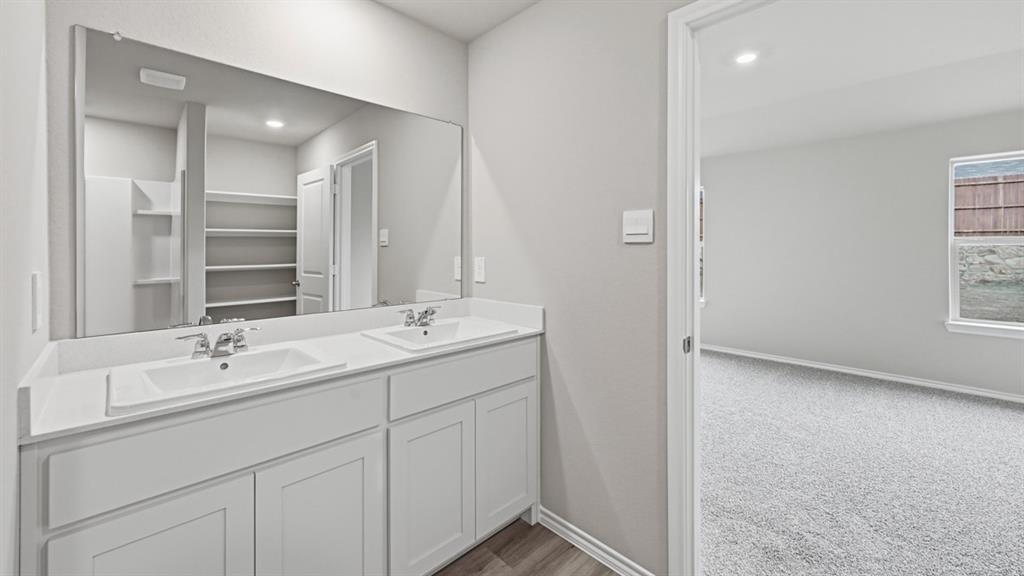 1632 Tin Roof Road Krum, TX 76249 - Photo 17 of 34 a bathroom with a double vanity sink and mirror