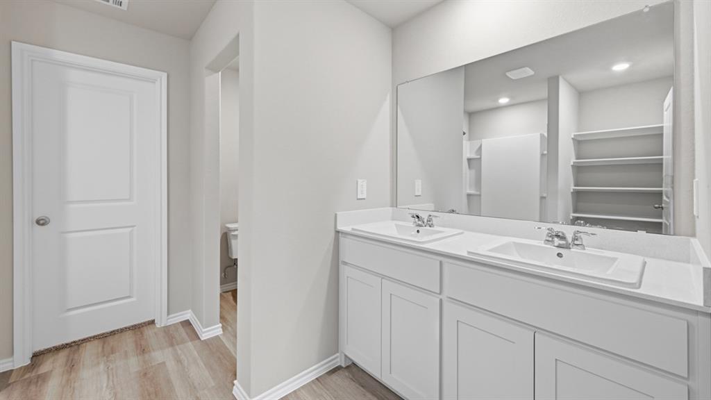 1632 Tin Roof Road Krum, TX 76249 - Photo 18 of 34 a bathroom with a double vanity sink and mirror