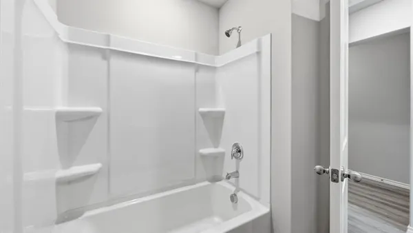 a view of an empty room and closet area