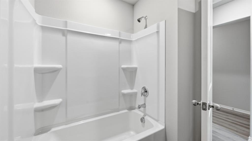 1632 Tin Roof Road Krum, TX 76249 - Photo 24 of 34 a bathroom with a bathtub and a shower