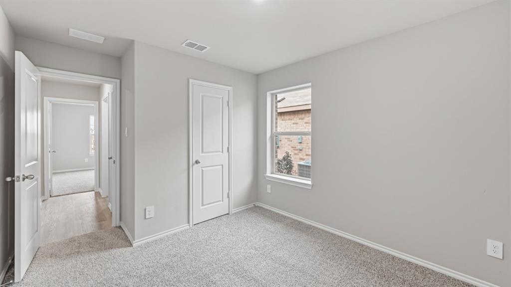 1632 Tin Roof Road Krum, TX 76249 - Photo 26 of 34 an empty room with windows and closet