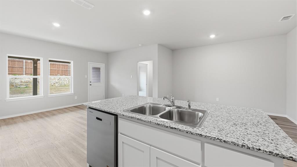 1632 Tin Roof Road Krum, TX 76249 - Photo 5 of 34 a kitchen that has a sink and cabinets
