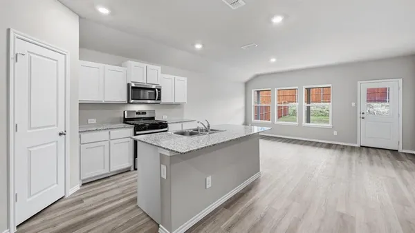 a kitchen with stainless steel appliances granite countertop a stove and a sink