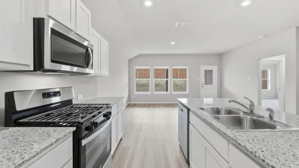 a kitchen that has a sink and cabinets