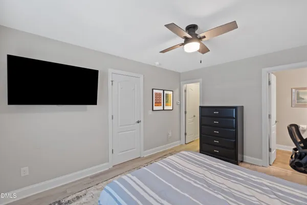 a view of a hallway with wooden floor and entryway