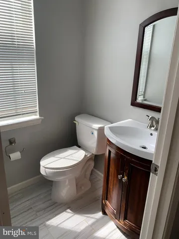 a bathroom with a sink toilet and mirror