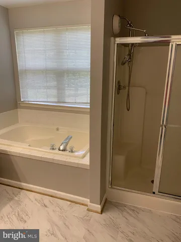 a bathroom with a bathtub and a shower