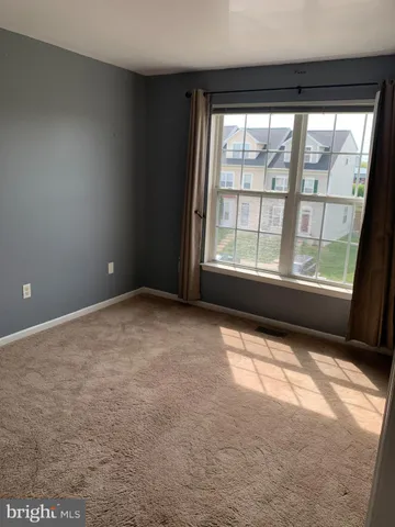 an empty room with large windows