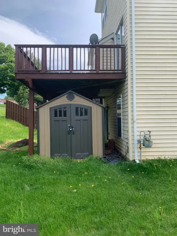 a view of a house with a yard and deck
