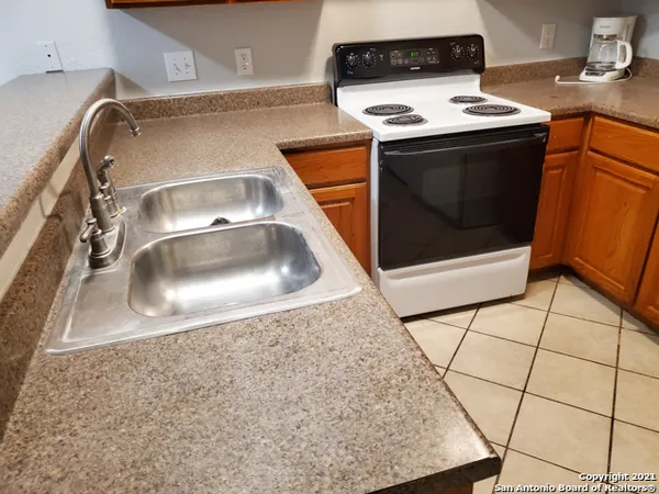 a close view of a sink a stove and washer