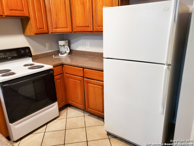 1431 Rivas Street San Antonio, TX 78207 - Photo 3 of 9 a kitchen with stainless steel appliances a refrigerator stove and cabinets
