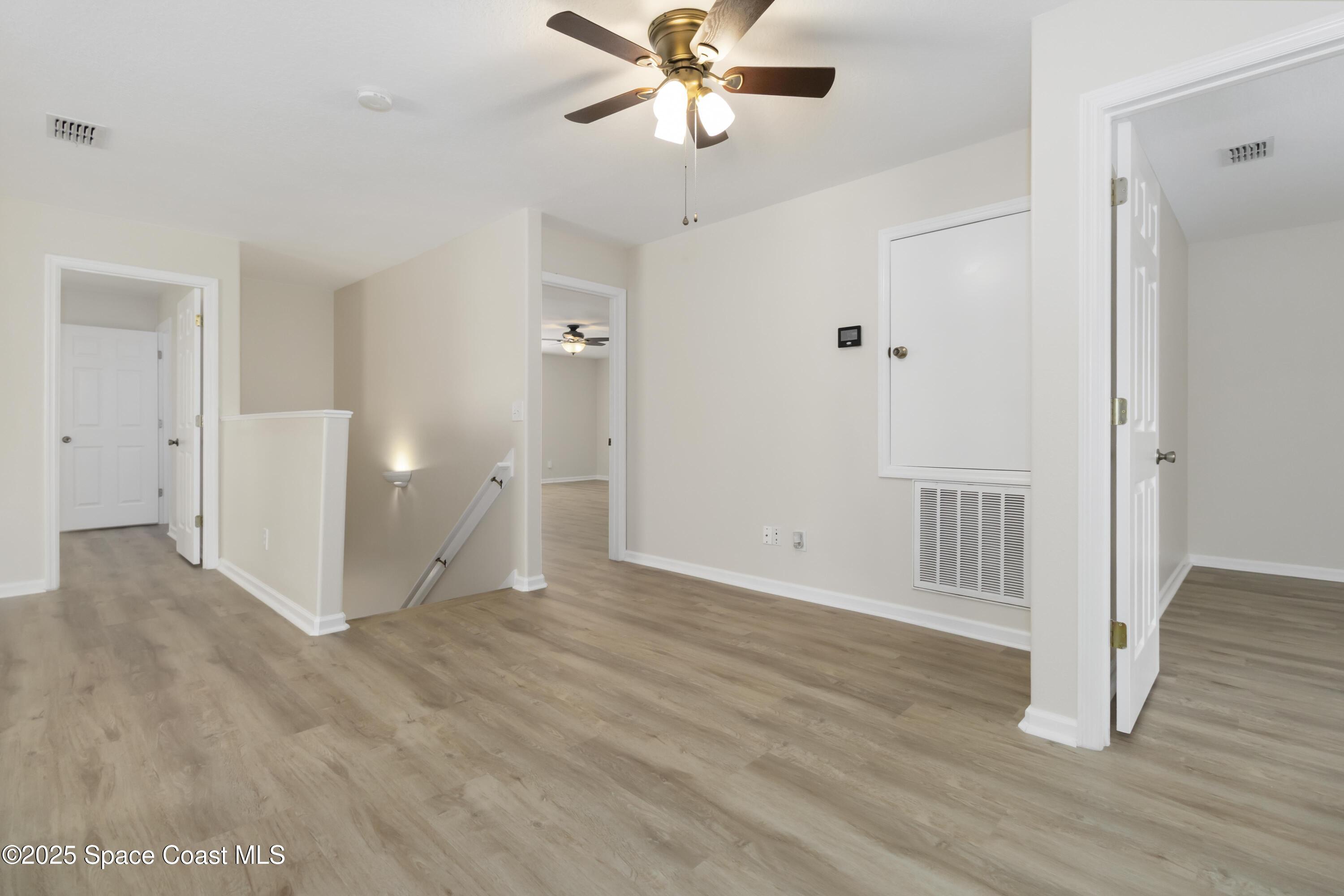 775 Russo Drive Melbourne, FL 32901 - Photo 11 of 29 wooden floor in an empty room with a window