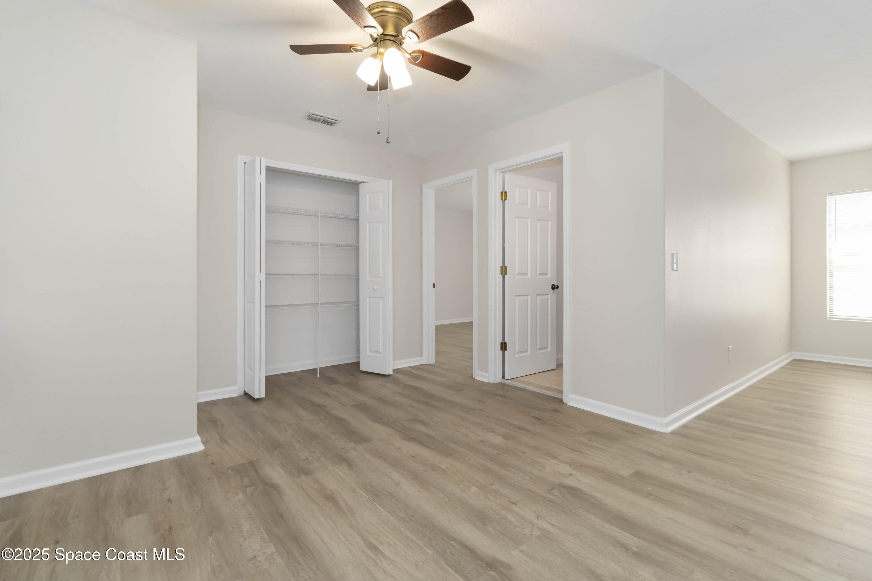 775 Russo Drive Melbourne, FL 32901 - Photo 12 of 29 a view of an empty room with wooden floor