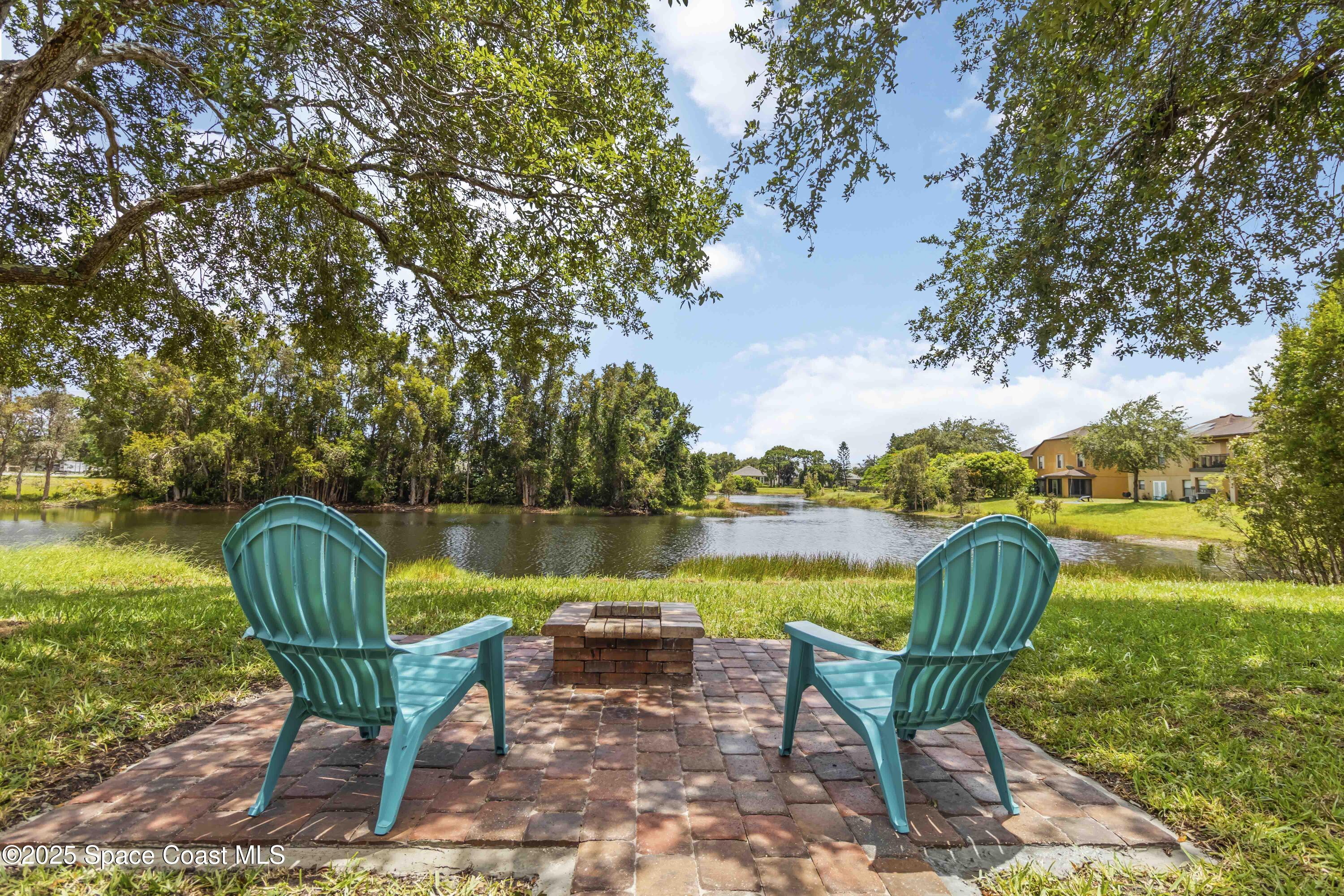 775 Russo Drive Melbourne, FL 32901 - Photo 22 of 29 a view of a lake with table and chairs