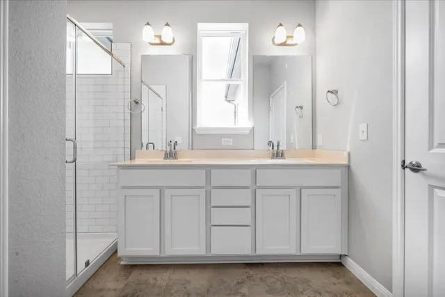 a bathroom with a shower sink and mirror