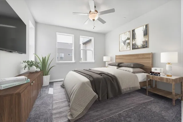 an empty room with windows and ceiling fan