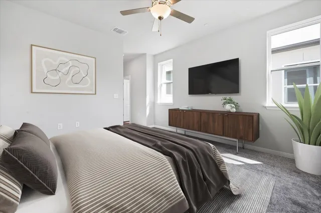 an empty room with a window and a fan