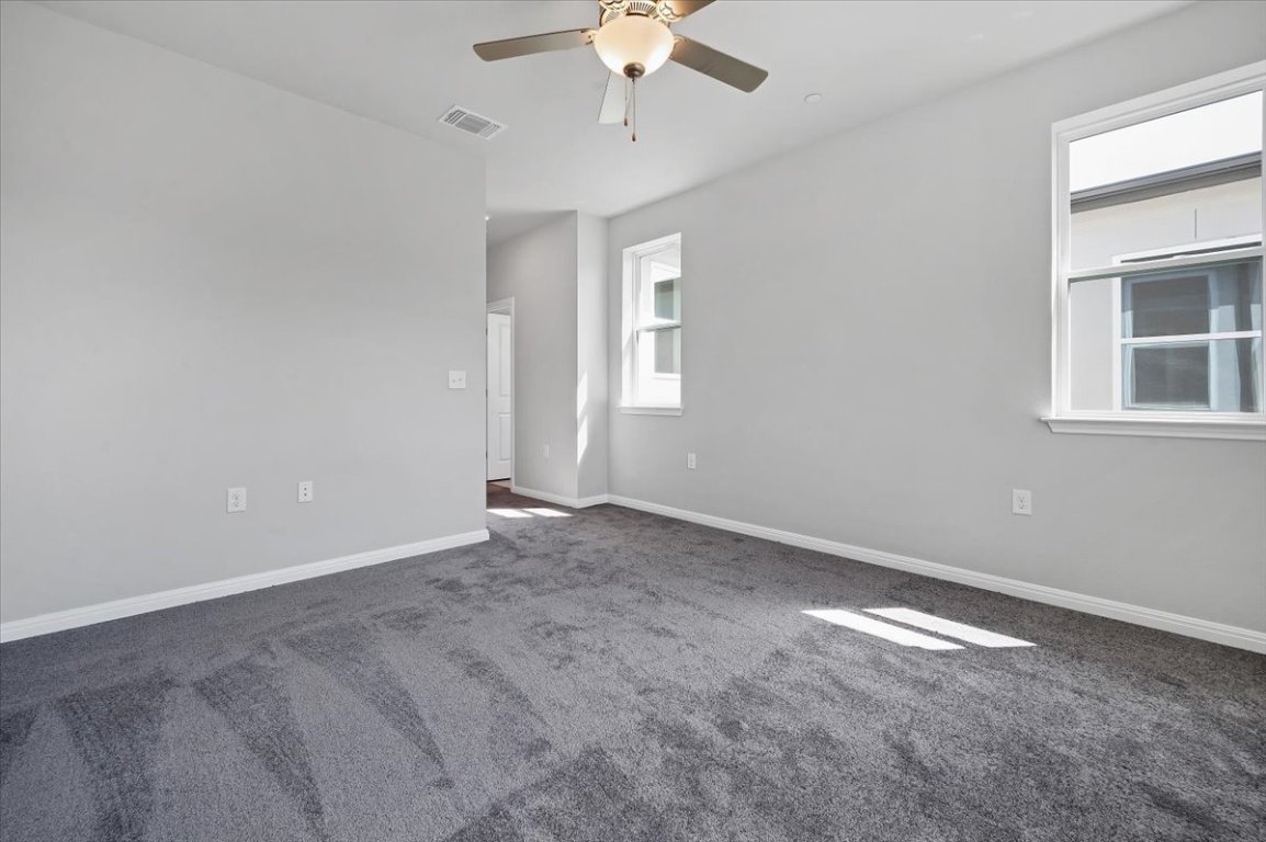 9015 Cattle Baron Path, Unit 1303 Austin, TX 78747 - Photo 23 of 29 an empty room with a window and a fan