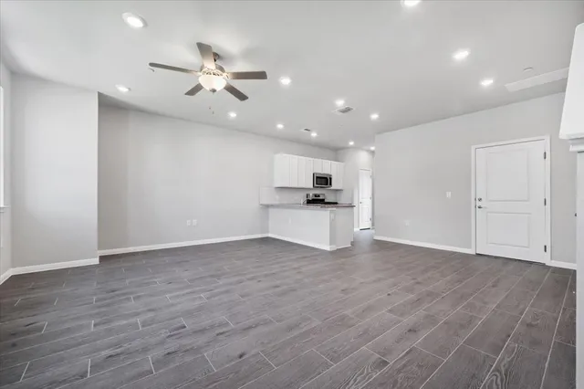 a living room with furniture a flat screen tv and a window