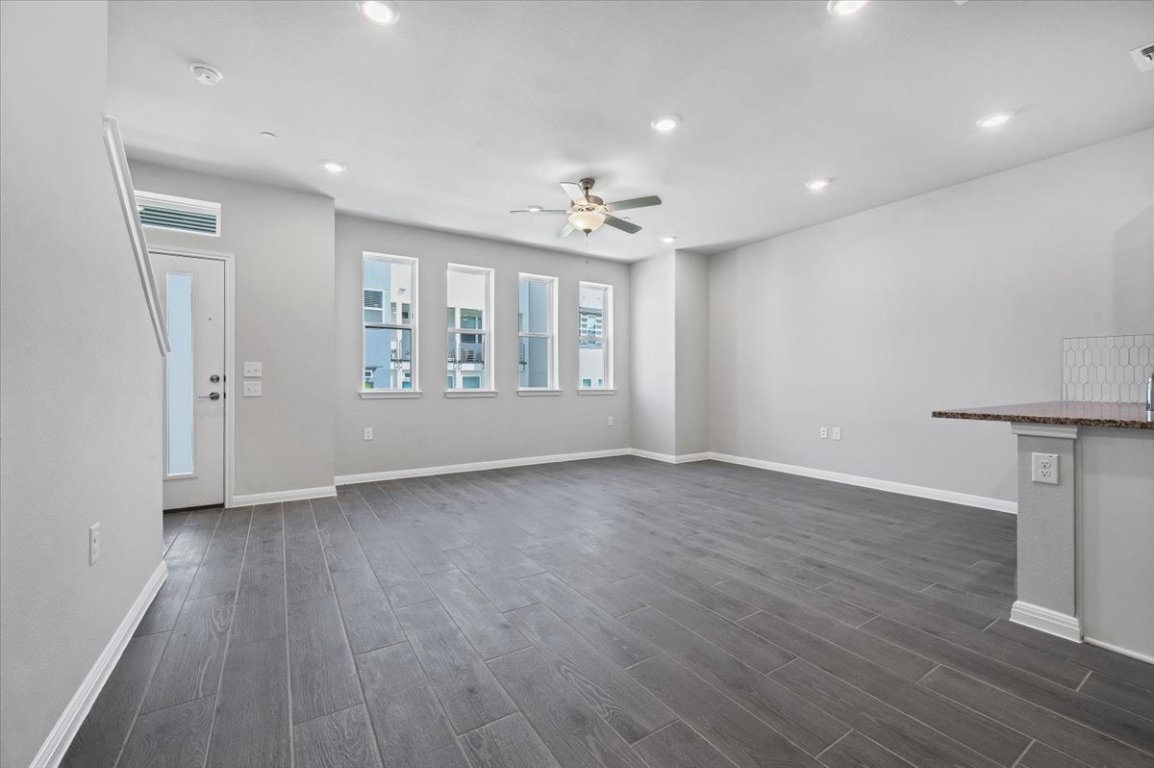 9015 Cattle Baron Path, Unit 1303 Austin, TX 78747 - Photo 5 of 29 a view of an empty room with a window and wooden floor