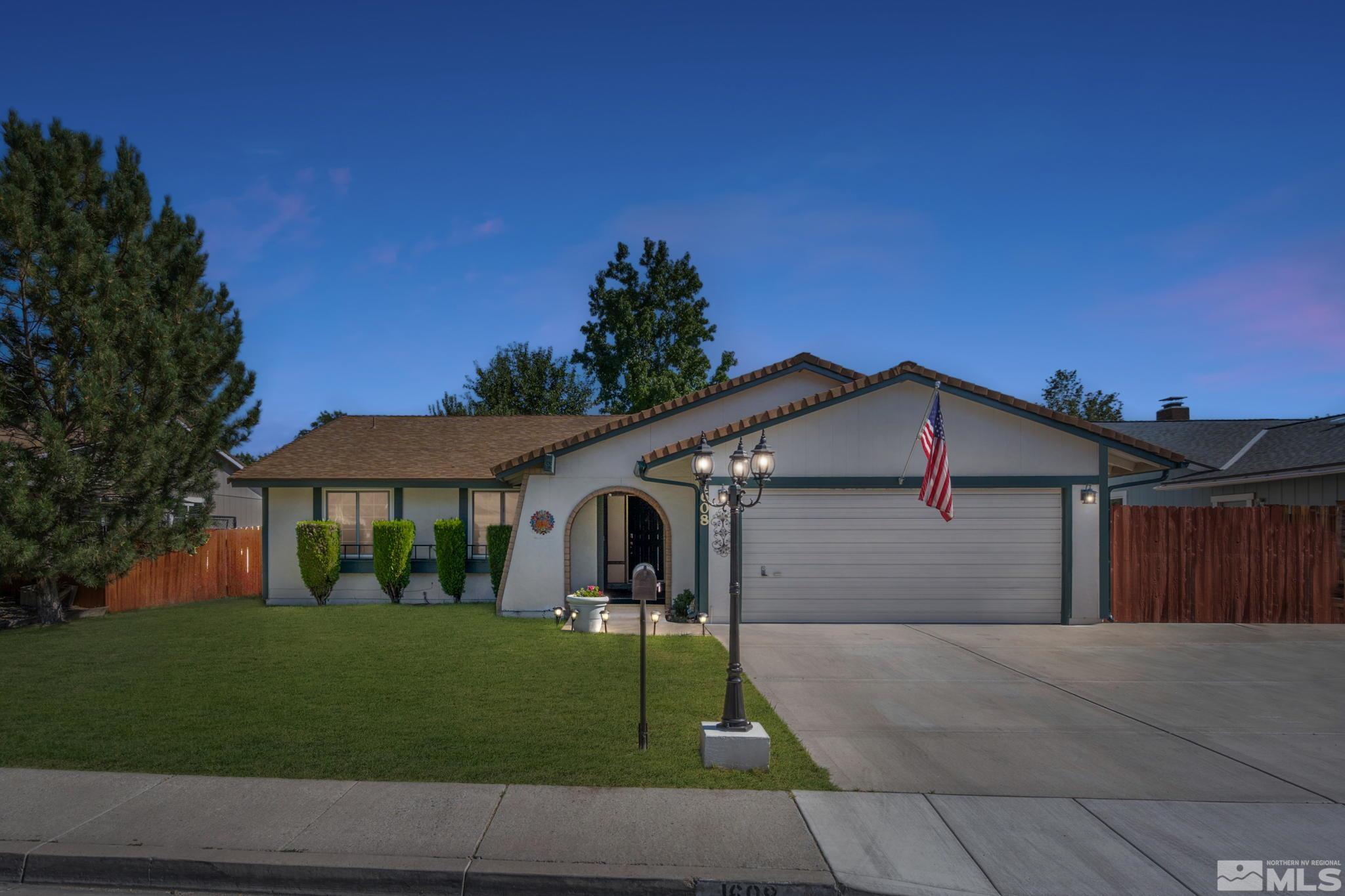 1608 Del Rosa Way Sparks, NV 89434 - Photo 1 of 18 a front view of a house with a garden