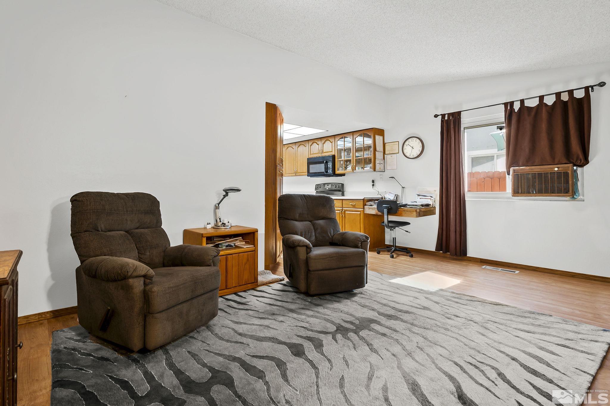 1608 Del Rosa Way Sparks, NV 89434 - Photo 11 of 18 a living room with furniture a rug and a window