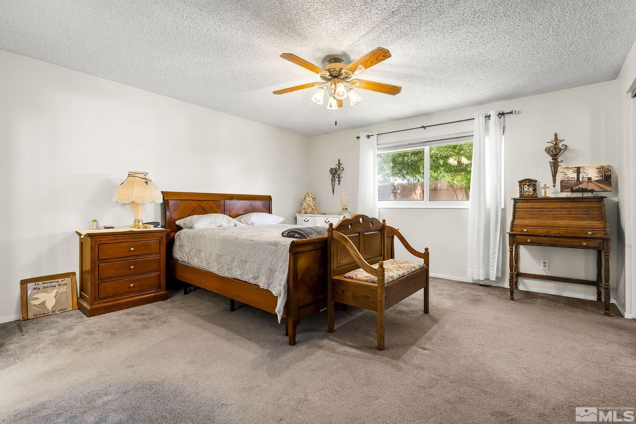 1608 Del Rosa Way Sparks, NV 89434 - Photo 12 of 18 a bedroom with a bed and a chandelier
